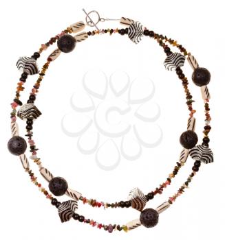 necklace from beads of black rock lava, carved bone, natural mineral stones, carved metal isolated on white background