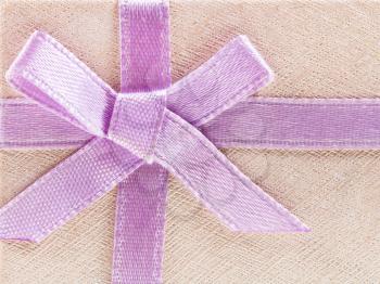 pink bow on shining paper gift box close up