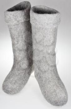 pair of knee-high felt boots on grey background