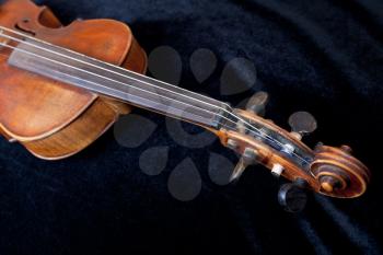 violin pegbox on black velvet background close up