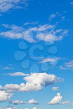 cloudscape with little white clouds in blue sky in summer day
