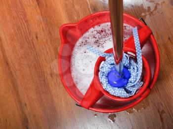 top view of mop in bucket with water for housework