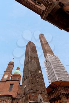 Two towers - symbol of city under blue sky in Bologna, Italy