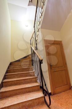 narrow front stone staircase in house