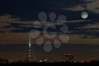 night urban panorama with full moon and Ostankino tower in Moscow