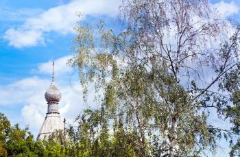 wooden dome of russian church and birch tree