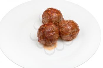roasted meatballs under meat sauce on white plate