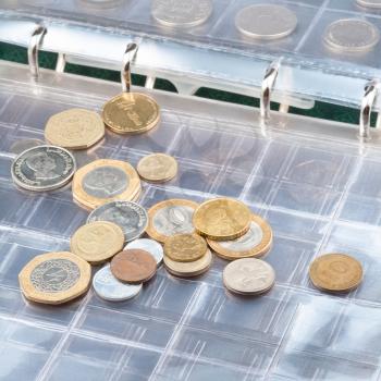 page of numismatics album with different coins