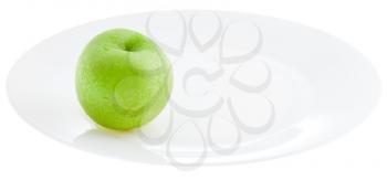 green apple on white plate isolated on white background