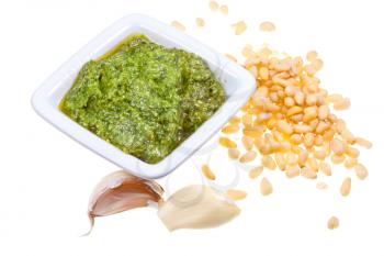 italian pesto with fresh pine nuts and garlic cloves isolated on white background