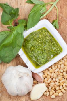 top view on italian pesto with fresh ingredient on wooden board