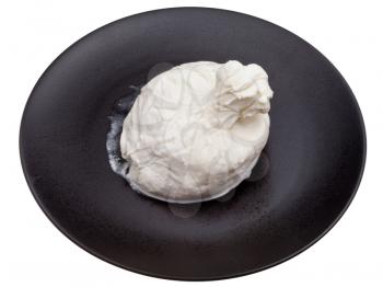 fresh italian cheese burrata on black ceramic plate isolated on white background