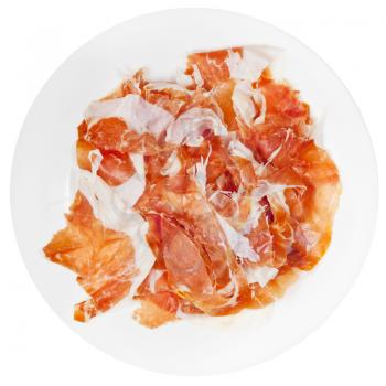 top view of sliced ham Prosciutto di Parma on plate isolated on white background