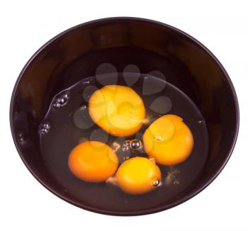 four chicken broken egg in black ceramic bowl isolated on white background
