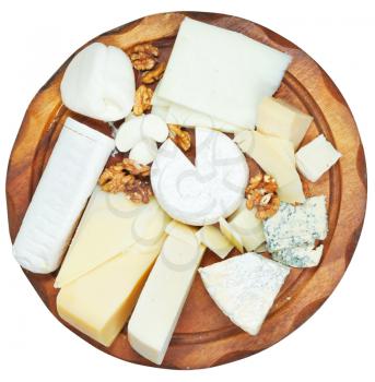 top view of wooden plate with various cheeses isolated on white background