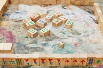 playing in mahjong board game by wooden tiles on shabby table