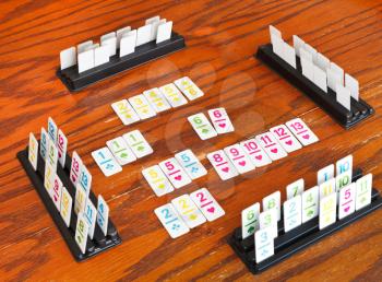 playing field of rummy card game on wooden table