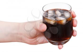 hand holds cola with ice in glass isolated on white background