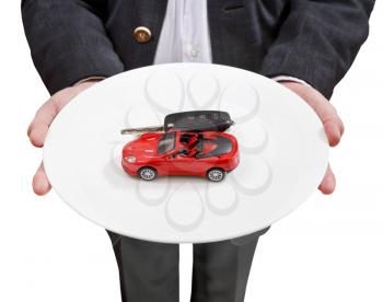 front view of businessman holds white plate with red car and key isolated on white background