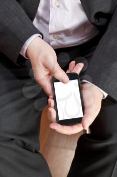 above view of touchscreen smartphone with cut out screen in male hands