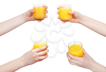 set of hand holds glass with orange juice isolated on white background