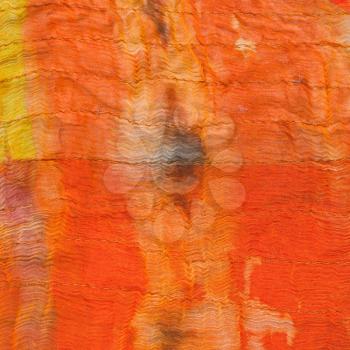 texture of painted orange silk batik close up