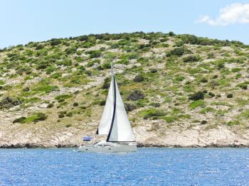 white yacht sailing near Dalmatia coast in Adriatic sea, Croatia