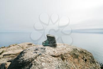 Pilgrim's boot on Cape Finisterre - the end of Way of St. James, Galicia, Spain