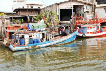 living boats on khlong of chao phraya river in bangkok, thailand