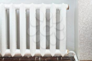 white painted iron radiator of water heating in home