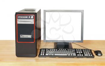 black desktop computer, display with cut out screen, keyboard, mouse on wooden table isolated on white background