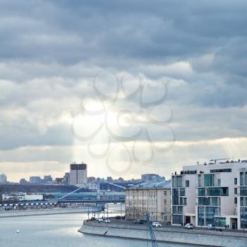 Moskva River, Prechistenskaya embankment, and sunbeams illuminating Moscow building of the Russian Academy of Sciences in cloudy autumn evening