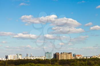 blue spring sky with white clouds over urban residential district