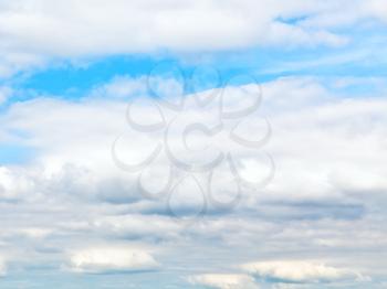 layers of white cumulus clouds in blue autumn sky - natural background