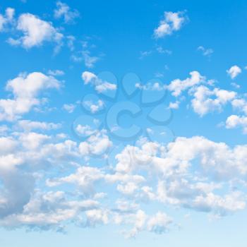 many little fluffy clouds in blue sky in summer