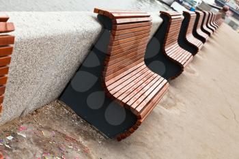 empty wooden benches on river embankment