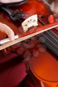 girl playing violin - strings and bow close up