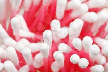 Many pink plastic cotton swabs close up