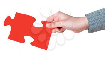 female hand with red puzzle piece isolated on white background