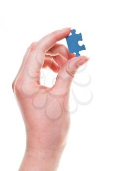 female arm with jigsaw puzzle piece isolated on white background