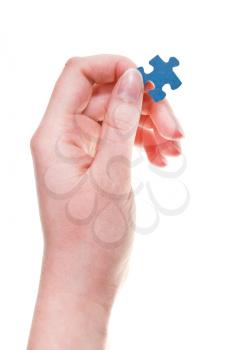 female hand keeps jigsaw puzzle piece isolated on white background
