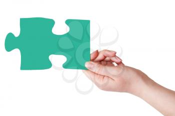 female hand with green puzzle piece isolated on white background