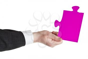 male hand holding big pink paper puzzle piece isolated on white background