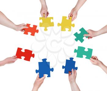 circle of people hands with puzzle pieces isolated on white background