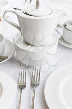 white porcelain tea set: teapot, saucer, cup