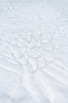 ski tracks and footpaths in snow in winter day