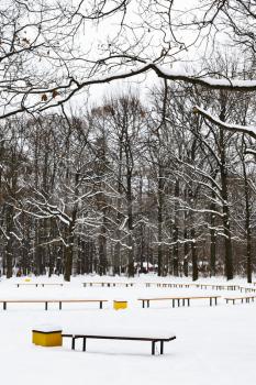 snow covered recreation ground in city park in winter