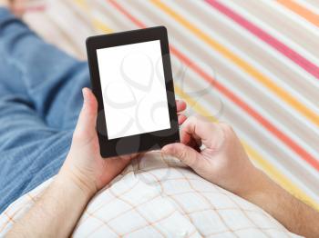 man reading with book reader with cut out screen in living room