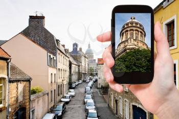 travel concept - tourist taking photo of Cathedral in Boulogne-Sur-Mer on mobile gadget, France