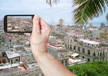 travel concept - tourist taking photo of old Havana city on mobile gadget, Cuba
